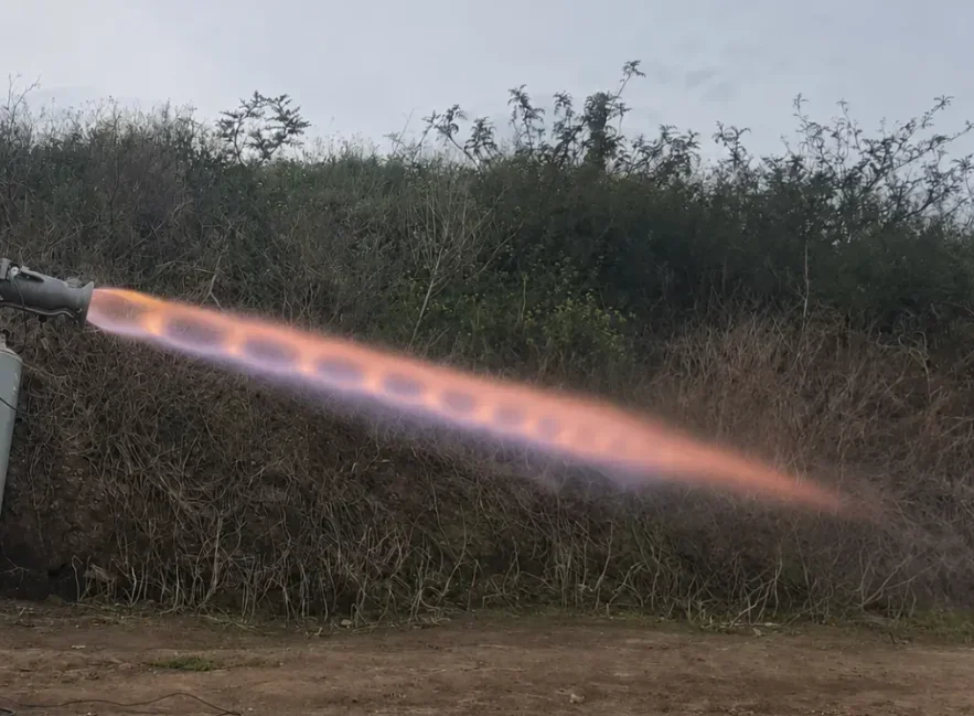 Engine hot-fire test showing full flame plume
